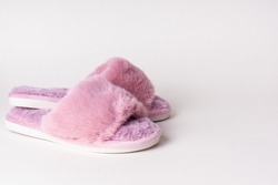Pink women's home slippers on light background. Comfortable shoes for home. Space for text