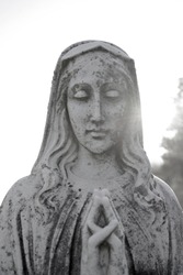 Virgin Mary. Praying holy mother Mary. Antique catholic statue representing blessed Mary with praying hands.