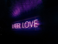 I feel love neon light sign in pink purple and blue
