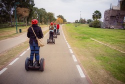 Group of people traveling on Segway in the park