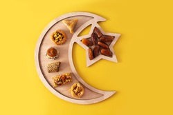 Assortment of Ramadan dessert baklava on yellow background