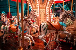 A night shot of a merry Go round, on a rainy night. 