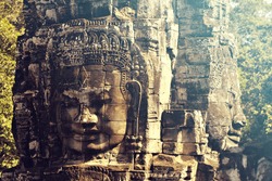 Stone heads which form part of the Bayon Temple in Angkor Thom, near Siem Reap, Cambodia. Vintage filter effect added.