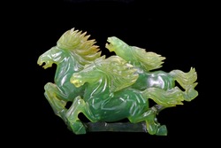 Jade carving : three horses running sculpture (Nephrite jade) isolated on black background
