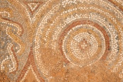 A fragment of a beautiful ancient mosaic of an ancient Roman structure, the archaeological site of Sbeitla, Tunisia.