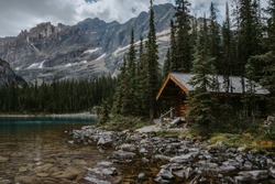 Cozy wooden cabin on shore of Lake Ohara in Yoho National Park, Canadian Rockies. Tourist/hikers summer accommodation in the mountains. Beautiful British Columbia, Canada
