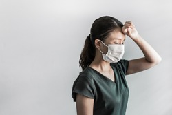 Asian Woman staff wearing face mask protection feeling sick during covid-19 or coronavirus outbreak on gray background.