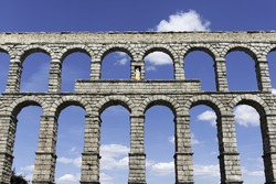 Front view of the famous Aqueduct bridge of Segovia on a clear Spring morning, a Roman aqueduct that is one of the most significant and well-preserved ancient monuments left on the Iberian Peninsula.