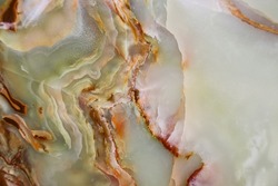 Close up of the pattern and color of the surface of a raw jade stone
