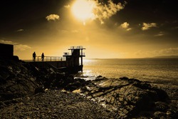 Blackrock Diving Tower is a pier with several diving platforms at different levels and is located at the end of Salthill's promenade with Galway Bay in the background