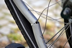 Partial view of a broken aluminum rim of a bicycle. 