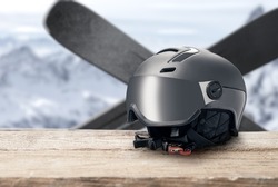 ski helmet with visor on mountains background. Modern grey helmet with sun visor on mountains background. winter sports helmet. Mountain Resort. copy space