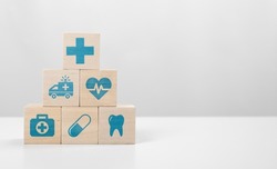 Medical icon on pyramid of cubes. medicine and health insurance concepts. Wooden blocks with icons of various types of insurance, icons healthcare medical symbol on wooden block