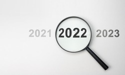 2022 inside of Magnifier glass on white background for focus current situation, positive thinking mindset concept. 2022 present in focus. 2021 2022 2023