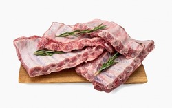 Raw pork ribs. Whole raw pork ribs on wooden board isolated background. Raw meat, farm and cooking concept. Meat shop. Racks of fresh raw pork meat ribs isolated on white background