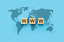 WWW World Wide Web on block letters. World map on blue background. Website development, www application coding, technology create online cyberspace software connect through internet.