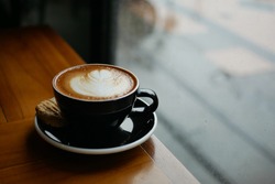 a cup of coffe latte near window