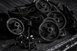 Black and white pile of gears at an abandoned silk mill.