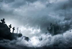Cemetery or graveyard in the night with dark sky and white clouds. Haunted cemetery. Spooky and scary burial ground. Horror scene of graveyard. Funeral concept. Sadness, lament and death background.