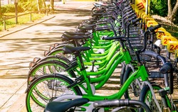 Bicycle sharing systems. Bicycle for rent business. Bicycle for city tour at bike parking station. Eco-friendly transport. Urban economy public transport. Bike station in the park. Healthy lifestyle.