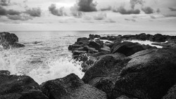 Black and white waves crashing on rocks in Mauritius.