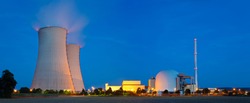 Panoramic view of a nuclear power plant with night blue sky.