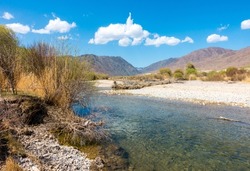 River among the mountains. Calm transparent ovda. Summer landscape. Boom Gorge, Kyrgyzstan