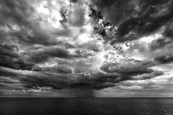 stormy clouds and rain over the sea