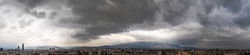 Aerial panorama from a drone of exciting stormy clouds over the city.