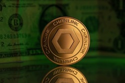 Chainlink LINK Cryptocurrency Physical Coin Placed on reflective surface with one dollar note behind and lit with green light