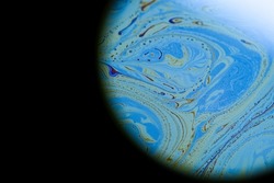 Psychedelic abstract blue planet in the darkness in universe. Closeup soap bubble like an alien planet on dark background