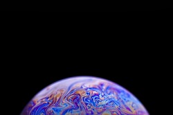 Multicolor abstract cold alien planet with an atmosphere in universe on dark background. Closeup soap bubble