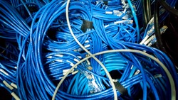 Untidy Coil of blue lan cable in the cabinet