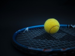 Sport and healthy lifestyle. Tennis. Yellow ball for tennis and a racket on table. Sports background with tennis concept, photo