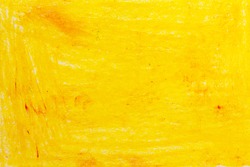 Yellow drawing on the wall with wax crayon. Orange abstract background with stripes and spots. Bright texture for a banner or poster