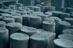 Graphite manufactured articles with unequal height standing at production department of modern plant, close-up shot