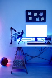 Vertical background image of gaming room with blue neon lighting and PC white screen mockup