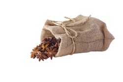 Star anise are falling from the burlap sack isolated on white background.With clipping path.