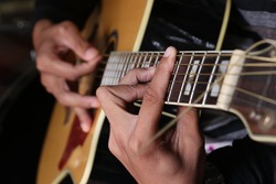 Holding chords to play guitar