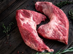 raw beef tri-tip steak for BBQ on wooden background, top view