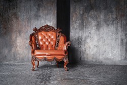 brown retro leather chair in livingroom. luxury place for relax. concrete wall in loft interior