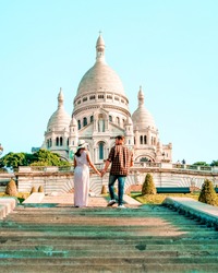 Sacre Coeur Cathedral in Montmartre, Paris, France, hill of Montmartre Paris with church ,couple walking at the hill