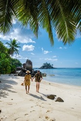 Mahe Seychelles, a tropical beach with palm trees, and a blue ocean at Mahe Seychelles. Anse Royale beach, couple man and woman on vacation Seychelles