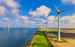 Windmill turbines at sea generate green energy in the Netherlands. Drone view at windmill park