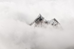 Mountain top surrounded by clouds