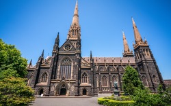 Side view of St Patrick's Cathedral and spire a Roman Catholic Cathedral church in Melbourne Victoria Australia