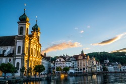 Sunset view in Lucerne with last sunray illuminating the beautiful Jesuit church facade in Lucerne old town Switzerland