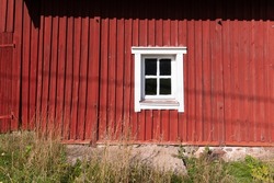 Close up of a white window in old red wooden traditional Finnish house, Turku, Finland.