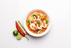 Flat lay, top view Spicy Thai Prawn Coconut Milk soup isolated on white background