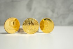 Three different virtual currencies: Bitcoin, Ethereum and Chainlink. Conceptual investment of new virtual currencies. High quality photo